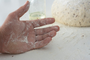 Man kneading a large dough for homemade bread in quarantine
