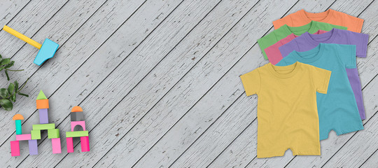 baby toys and clothes on wooden background