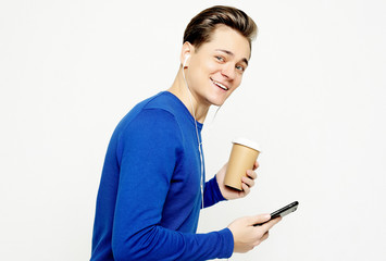Fototapeta premium Portrait of happy man talking on phone and drinking coffee