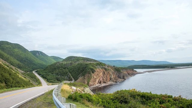 A timelapse of the Cabot Trail with dramatic clouds overlooking the Atlantic Ocean and the Cabot Trail and  scenic landscape inside the Cape Breton Island National Park, Nova Scotia, Canada
