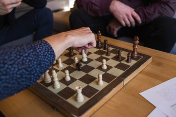 Men play chess in a stylish loft cafe with a modern design.