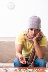 Fototapeta premium Young man suffering at home