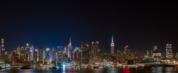 Fototapeta na wymiar Wide panorama image of skyscrapers in Manhattan, New York at night