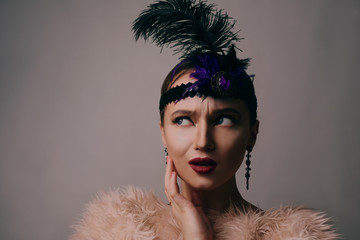Girl in the 90s style, chicago style. Hat, headband with decorative feathers on the head....