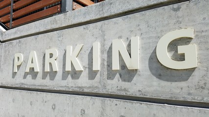 Parking garage signage on building concrete wall