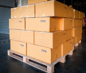 Stack of cardboard boxes on wooden pallets, package boxes, interior of warehouse storage, manufacturing  plant shipping logistics and transport                 
