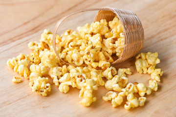 Popcorn in wooden basket and wood backgroubd - Sweet butter popcorn salt