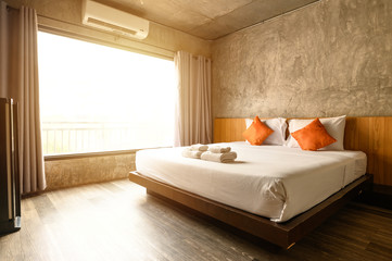 The comfortable hotel bedroom in cozy style. Conceptual of interior design in hotel.