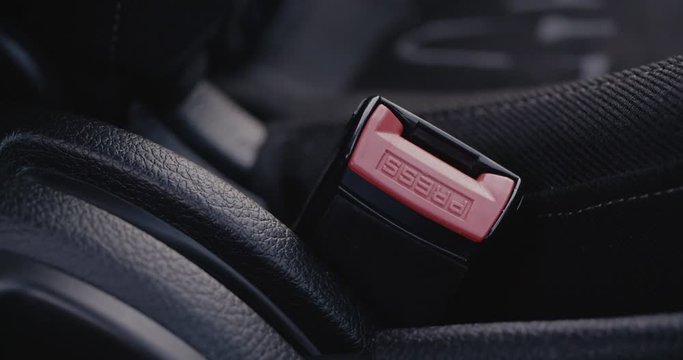 Vehicle safety concept - closeup shot of a car seat belt buckle.