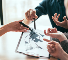 close up. a group of employees discussing ideas for a new startup. Elements of this image furnished...