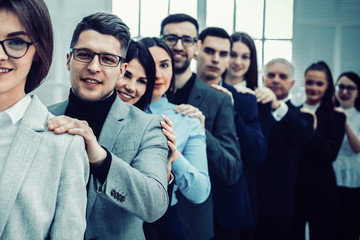 group of young business people standing behind each other