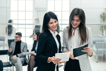 two business women discussing business documents in the office