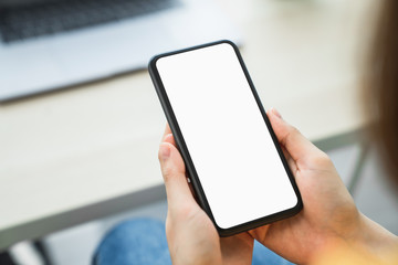 Woman hand holding smartphone and touching blank screen. Mockup of advertisement.