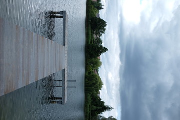 Empty Jetty At Lake Against Cloudy Sky