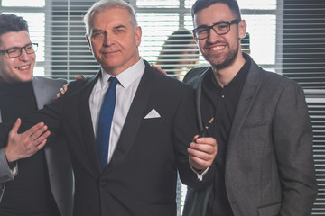 boss and happy business team standing in office lobby