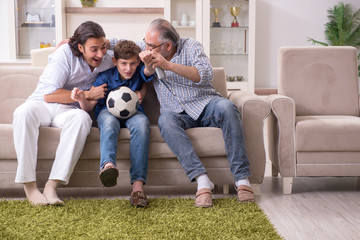 Boy and his father and his grandfother indoor