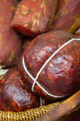 Freshly smoked ham for sale in basket on stall