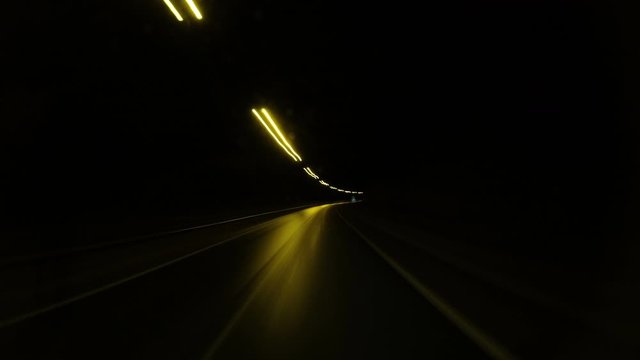 Time Lapse. Car driving fast on road at night.