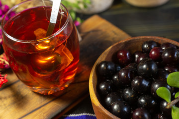 Black berries, with a tea and pieces of cheese on black background