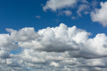 Naklejka na ściany i meble Incredibly beautiful fluffy clouds on a sunny spring day.