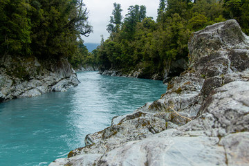 Bright blue river with white rocks