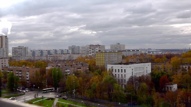 time laps video from the 10th floor to a sleeping area of Moscow autumn day. Moscow time lapse crossroads with cars and people, changing light on colorful trees