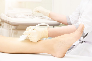 Obraz na płótnie Canvas Doctor ultrasound knee test. Scan medical equipment. Diagnosis ultrasound foot. Varicose ankle exam tool.