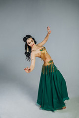 Dance of a beautiful girl in an Indian costume