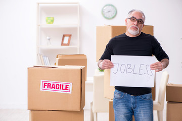 Old male professional mover doing home relocation