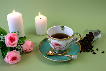 Obraz na płótnie Canvas coffee, flowers, candles on a pistachio background as a symbol of home warmth and coziness, beauty and a wonderful morning