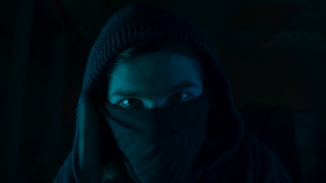 A thief with mask was stealing someone's money and threaten him by knife. Busted by the police. Thief concept. Slow motion 4k footage.