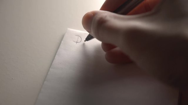 Free Handwriting On A Blank White Pad Paper With A Black Ink Pen - Closeup Shot