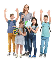 Obraz premium Happy little pupils with math teacher on white background