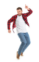 Handsome young man dancing against white background