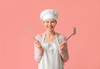 Fototapeta premium Beautiful female chef on color background