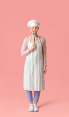Beautiful female chef on color background