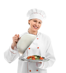 Beautiful female chef with salad on white background