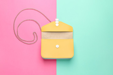 Stylish bag on color background
