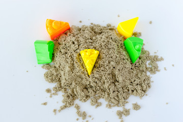 Childrens hands plays kinetic sand in quarantine. purple sand on a white table