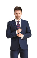 Handsome young man in elegant suit on white background