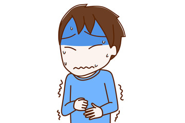 お腹が痛くて真っ青になっている少年