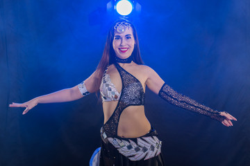 Girl dancing belly dance, fusion or tribal. A woman in a beautiful costume demonstrates charming and gentle movements in the dance.