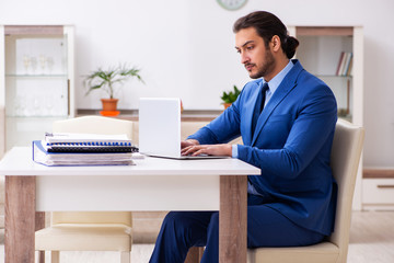 Young male employee in self-quarantine concept