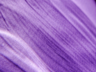 Abstract background made by rays of light refracted through a glass goblet on textured colored paper.