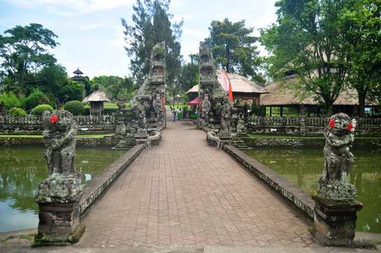 Ancient roadbridge crossing canal go to entrance to inner of Pura Taman Ayun or Mengwi Temple archaeological site for travelers people go to travel visit in at Badung city in Bali, Indonesia