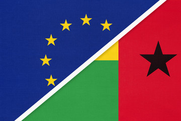 European Union or EU and Guinea-Bissau national flag from textile. Symbol of the Council of Europe association.