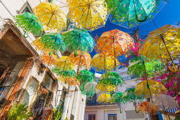 Different Umbrellas as a street decoration in old town on summer sunny day
