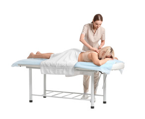 Massage therapist working with female patient on white background