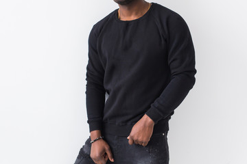 Street fashion concept - Close-up of African man wearing sweatshirt against white background.