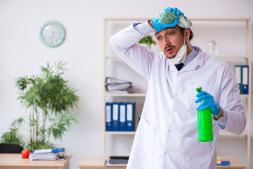 Young male doctor virologist in the office